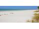 White sand beach with turquoise water at 1080 W Peppertree Ln # 506A, Sarasota, FL 34242