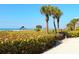 Beachfront view with grill and tropical landscaping at 1080 W Peppertree Ln # 506A, Sarasota, FL 34242