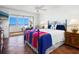 Ocean view bedroom with tiled floors, comfortable bed, and ceiling fan at 1080 W Peppertree Ln # 506A, Sarasota, FL 34242