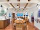 Bright dining room with terracotta floors, wood beam ceiling, and ocean view at 1080 W Peppertree Ln # 506A, Sarasota, FL 34242