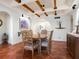 Charming dining room with terracotta tile floors and wood beam ceilings at 1080 W Peppertree Ln # 506A, Sarasota, FL 34242
