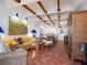 Spacious living room with terracotta floors, wood beam ceilings, and artwork at 1080 W Peppertree Ln # 506A, Sarasota, FL 34242
