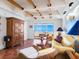 Bright living room with terracotta tile floors, wicker furniture, and ocean views at 1080 W Peppertree Ln # 506A, Sarasota, FL 34242