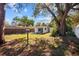 Spacious backyard with large trees and a patio area at 2369 Browning St, Sarasota, FL 34237