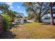 Large backyard with grassy area and wooden fence at 2369 Browning St, Sarasota, FL 34237