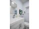 Clean bathroom boasts a double vanity, large mirror, and updated fixtures at 2369 Browning St, Sarasota, FL 34237