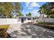Front view of a white house with a driveway and fenced yard at 2369 Browning St, Sarasota, FL 34237