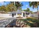 Charming white house with blue accents and a well-manicured lawn at 2369 Browning St, Sarasota, FL 34237