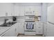 Clean and bright kitchen with white cabinets and a subway tile backsplash at 2369 Browning St, Sarasota, FL 34237