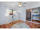 Bright sunroom features terracotta tile flooring, sliding glass doors to bedroom, and ceiling fan at 2369 Browning St, Sarasota, FL 34237