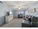 Spacious living area with gray carpet and comfy seating at 305 30Th W Ave # A208, Bradenton, FL 34205