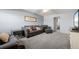 Comfortable living room with leather furniture and gray carpet at 305 30Th W Ave # A208, Bradenton, FL 34205