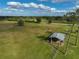 Aerial view of property showing large pasture, barn, and outbuildings at 3120 Lena Ln, Sarasota, FL 34240