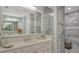 Spa-like bathroom with a walk-in shower and double vanity at 505 Tamiami N Trl # 201, Venice, FL 34285