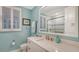 Light and airy bathroom with white vanity and a shower at 505 Tamiami N Trl # 201, Venice, FL 34285