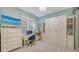 A bedroom with white built-in cabinets, a shuttered window, and a desk with a computer, offering a serene retreat at 505 Tamiami N Trl # 201, Venice, FL 34285
