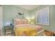 A charming bedroom featuring shuttered windows, a decorative mermaid wall hanging, and a coral-themed bedspread at 505 Tamiami N Trl # 201, Venice, FL 34285