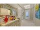 Elegant foyer with marble floors, stylish furniture, and a decorative mirror creating a welcoming ambiance at 505 Tamiami N Trl # 201, Venice, FL 34285