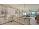 Open-concept kitchen with marble island and bright cabinetry flowing into the modern living area at 505 Tamiami N Trl # 201, Venice, FL 34285