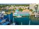 Aerial shot of waterfront restaurant featuring a dock and turquoise-colored building on the water's edge at 505 Tamiami N Trl # 201, Venice, FL 34285