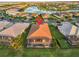 Aerial view of home with pool overlooking a pond in a serene, well-planned community at 5050 Surfside Cir, Lakewood Ranch, FL 34211