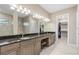 Lavish bathroom featuring a granite countertop, double vanity, and a clear view into the walk-in closet at 5050 Surfside Cir, Lakewood Ranch, FL 34211