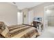 Cozy bedroom with a decorative bed frame, a desk for work, and an ensuite bathroom for convenience at 5050 Surfside Cir, Lakewood Ranch, FL 34211