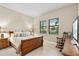 This bedroom features neutral walls, tile floors, and windows with scenic outside views at 5050 Surfside Cir, Lakewood Ranch, FL 34211