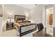 Elegantly furnished bedroom with a tufted headboard, stylish nightstands, and a cozy reading nook at 5050 Surfside Cir, Lakewood Ranch, FL 34211