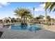 Inviting community pool featuring palm trees, lounge chairs, and shaded cabanas for relaxation at 5050 Surfside Cir, Lakewood Ranch, FL 34211