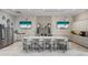 Modern kitchen with stainless steel appliances, marble countertops, and TVs for entertainment at 5050 Surfside Cir, Lakewood Ranch, FL 34211