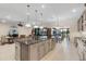 Open kitchen with center island and views of living area and outdoor space at 5050 Surfside Cir, Lakewood Ranch, FL 34211