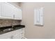 Laundry room with cabinetry, counter space, a sink, and an electronic control panel at 5050 Surfside Cir, Lakewood Ranch, FL 34211