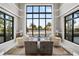 Relaxing lounge area with large windows overlooking the community pool and palm trees at 5050 Surfside Cir, Lakewood Ranch, FL 34211