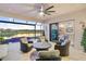 Covered patio area features comfortable seating, a ceiling fan, and views of the lake and pool at 5050 Surfside Cir, Lakewood Ranch, FL 34211