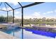 Beautiful private screened pool and spa, with a lake view and blue accent lighting at 5050 Surfside Cir, Lakewood Ranch, FL 34211