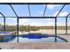 Screened pool with water feature and tranquil lake view at 5050 Surfside Cir, Lakewood Ranch, FL 34211