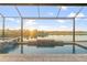 Beautiful pool area with lake views and serene privacy provided by the screened enclosure at 5050 Surfside Cir, Lakewood Ranch, FL 34211