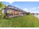 A spacious screened patio overlooks a well-maintained lawn and a tranquil lake with a fountain at 5050 Surfside Cir, Lakewood Ranch, FL 34211