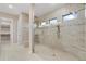 Spacious walk-in shower with multiple shower heads and built-in seating at 5050 Surfside Cir, Lakewood Ranch, FL 34211