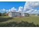 Home exterior view, spacious backyard with deck at 740 Floral Ln, Port Charlotte, FL 33952