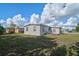 Home exterior view, spacious backyard with deck at 740 Floral Ln, Port Charlotte, FL 33952