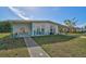 Charming ranch home with a landscaped lawn and walkway at 740 Floral Ln, Port Charlotte, FL 33952