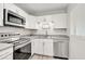 Modern kitchen with white cabinets and stainless steel appliances at 740 Floral Ln, Port Charlotte, FL 33952