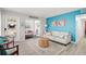 Bright living room featuring a comfy sofa and coastal decor at 740 Floral Ln, Port Charlotte, FL 33952