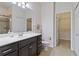 Bathroom with dark vanity, walk-in shower, and linen closet at 7786 Moonstone Dr # 7-204, Sarasota, FL 34233