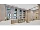 Modern bar area with decorative shelving, sleek countertops, and a functional mini-fridge at 111 S Pineapple Ave # 1018, Sarasota, FL 34236