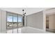 Bedroom features tile floors, a ceiling fan, and a sliding glass door to a balcony at 111 S Pineapple Ave # 1018, Sarasota, FL 34236