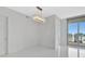 Bedroom with tile floors, sliding glass doors to a balcony, and modern light fixture at 111 S Pineapple Ave # 1018, Sarasota, FL 34236