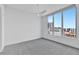 Bedroom featuring carpet flooring, a modern ceiling fan, and a view of the city at 111 S Pineapple Ave # 1018, Sarasota, FL 34236